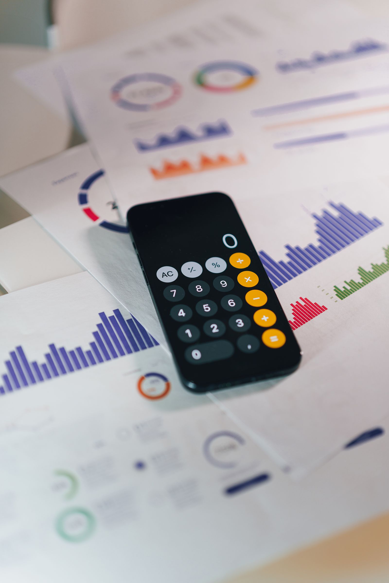 A calculator and printed financial statements on a desk, used to value a business