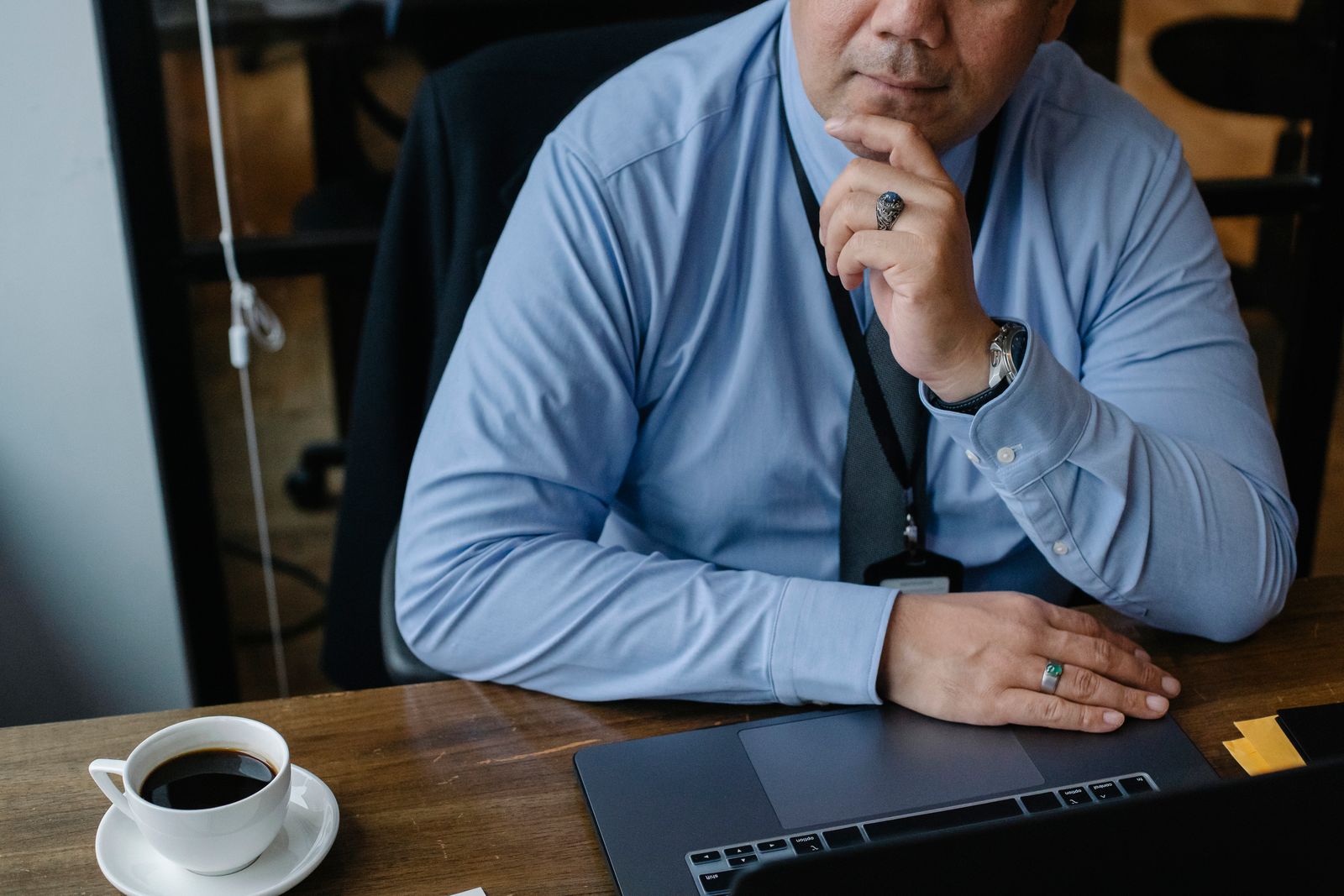 A business owner at a desk, deep in thought, weighing up when to start planning their exit